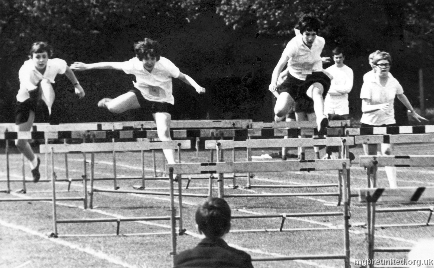 1968 Hurdles Vicky Moore, Pam McClure, Julie Williamson, Libby (Liz) Christine. John Holvey in the background.